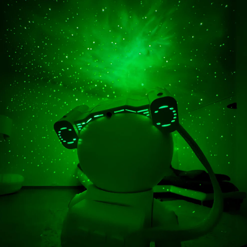 Green galaxy projection lighting a room behind the astronaut projector