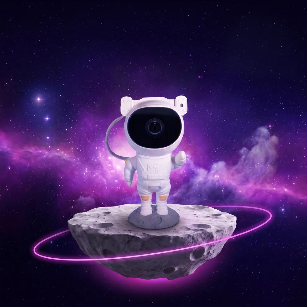 White astronaut galaxy projector on its moon base against a purple galaxy background